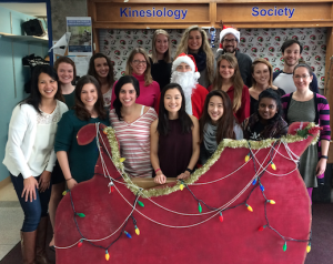 Members from the Vascular Dynamics Lab stand behind a red sleigh 